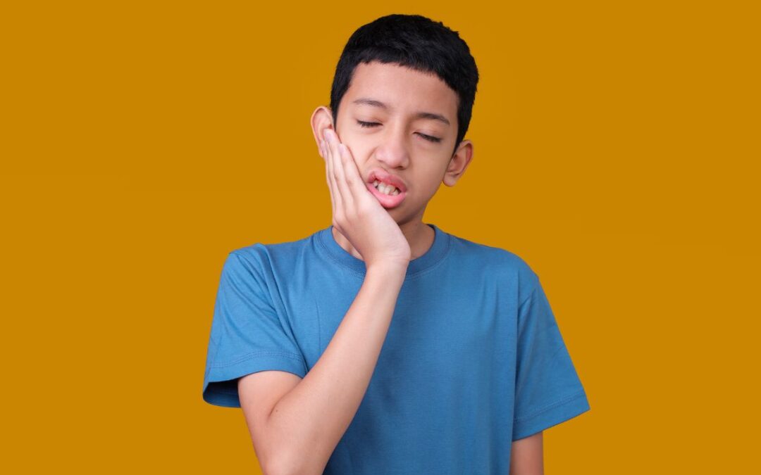 child experiencing tooth pain and discomfort